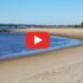 A person is walking on a sandy beach near Salisbury Beach Webcam.